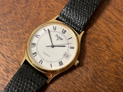 (1990) Pulsar Y552-8009 dress watch - gold colored case - white dial w/ black Roman numerals (NOS)