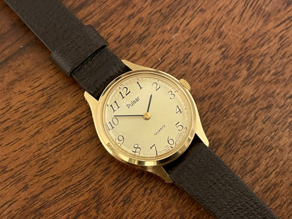 (1990) Pulsar Y480-0060 dress watch - gold colored case - champagne dial w/ black Arabic numerals - small size (NOS)