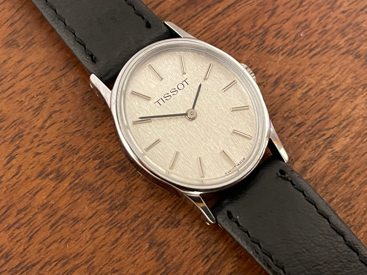 (1970s) Tissot 052-10991 Stylist dress watch - silver oval case - silverdust dial w/ silver stick markers - small size (NOS)