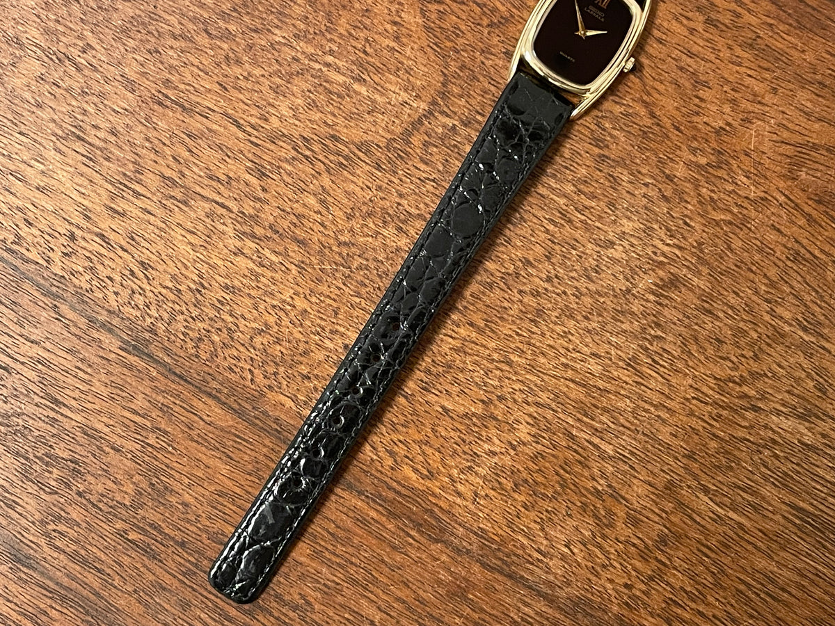 (1980) Seiko 1400-7249 Lassale "Ellipse" dress watch - black dial w/ gold Roman numerals - small size (NOS)