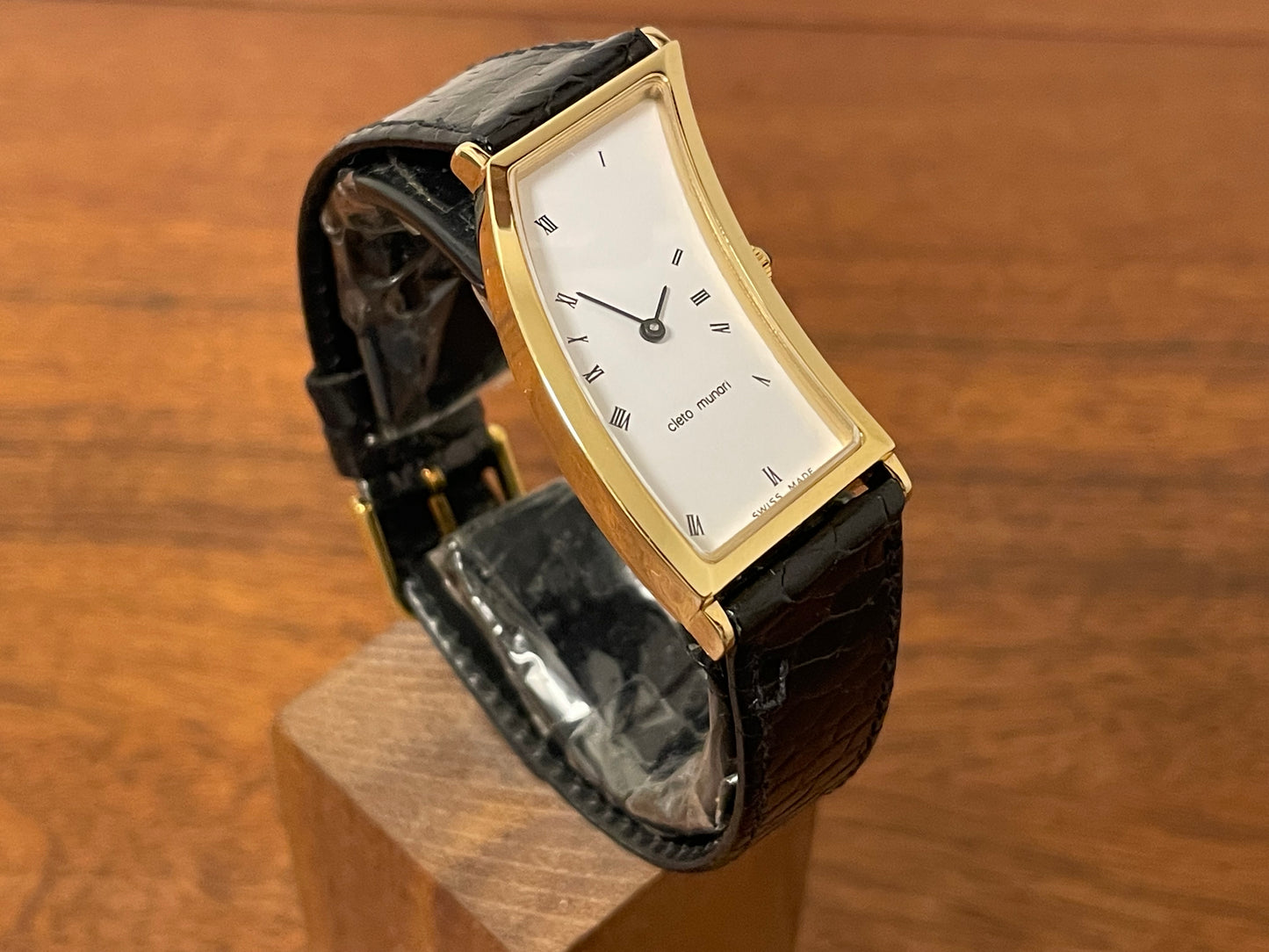 (1988) Cleto Munari "Parentesi" by Hans Hollein - asymmetrical 18K gold electroplated case - white dial w/ Roman numerals  (NOS + full set)
