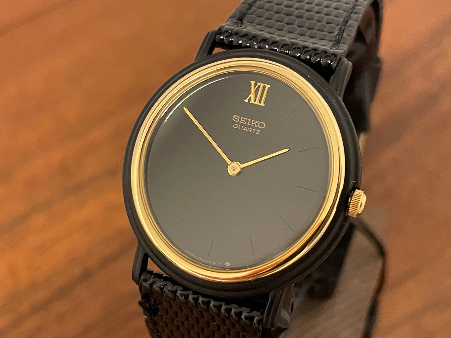 (1993) Seiko 6530-5120 dress watch- oval black case w/ gold bezel en hands (NOS)
