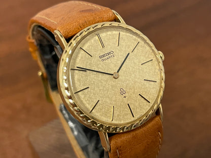 (1977) Seiko 43-0150 14K solid gold dress watch - rope bezel -  gold textured dial w/ gold markers