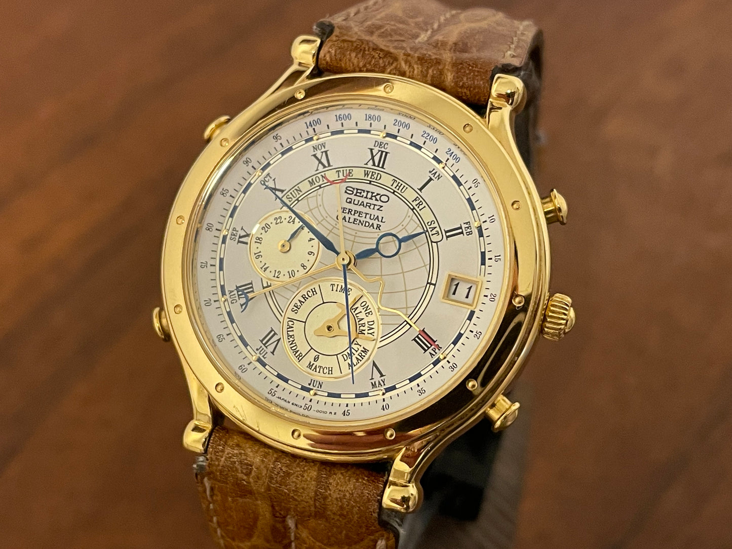 (1994) Seiko 6m13-0010 Age of Discovery (AOD) Perpetual Calendar - gold colored case - white dial w/ black Roman numerals