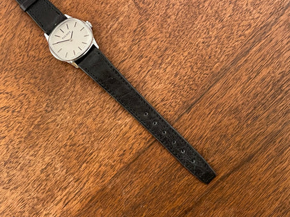 (1970s) Tissot 052-15007 Stylist dress watch - silver cushion case - silver brushed dial w/ silver stick markers - small size (NOS)