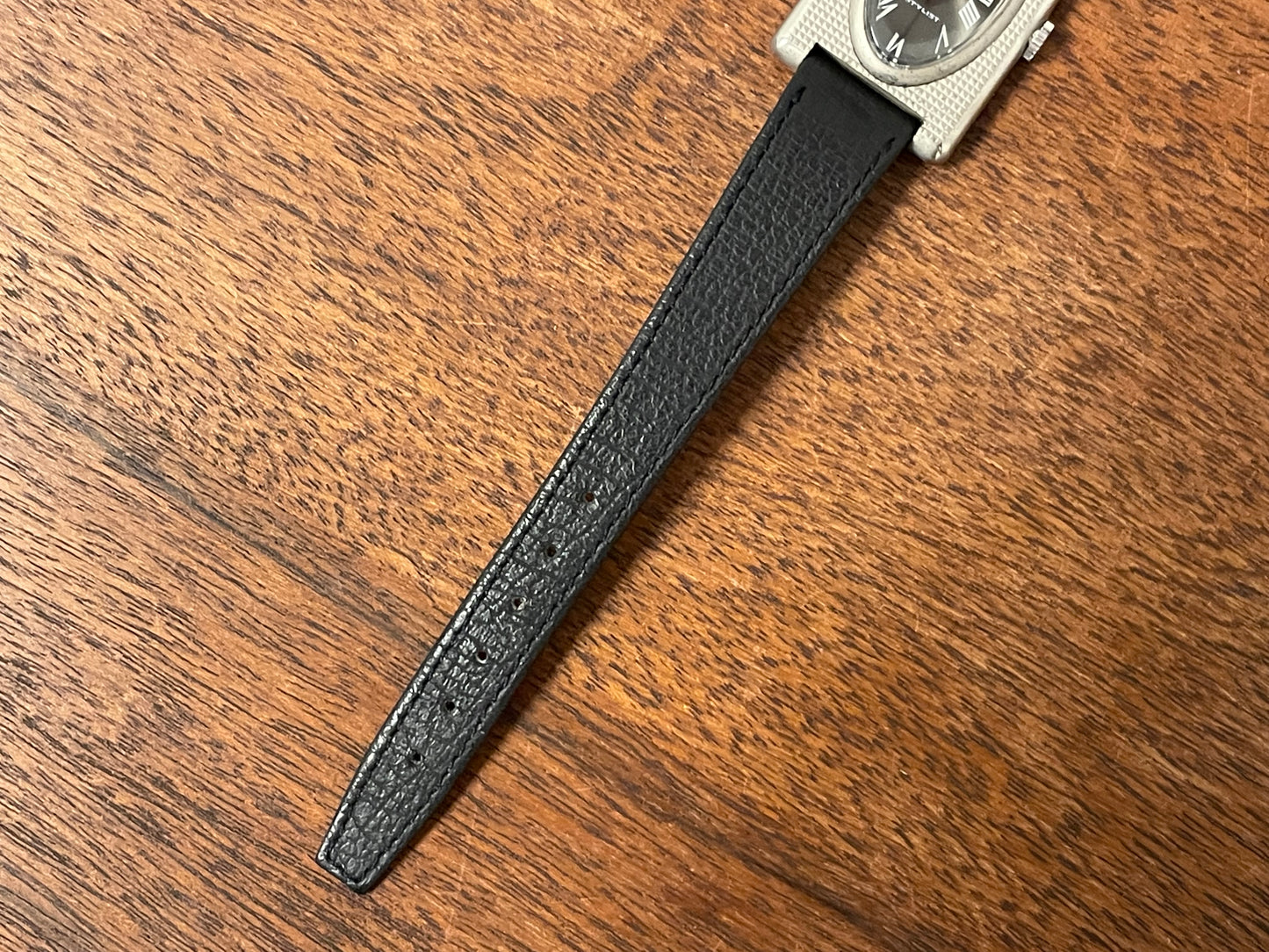 (1970s) Tissot Stylist "Tank" - decorated case - black sunburst dial w/ white Roman numerals - small size (NOS)