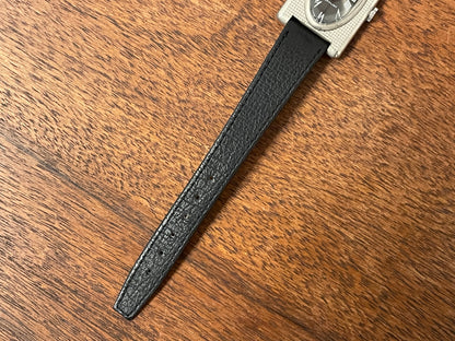 (1970s) Tissot Stylist "Tank" - decorated case - black sunburst dial w/ white Roman numerals - small size (NOS)