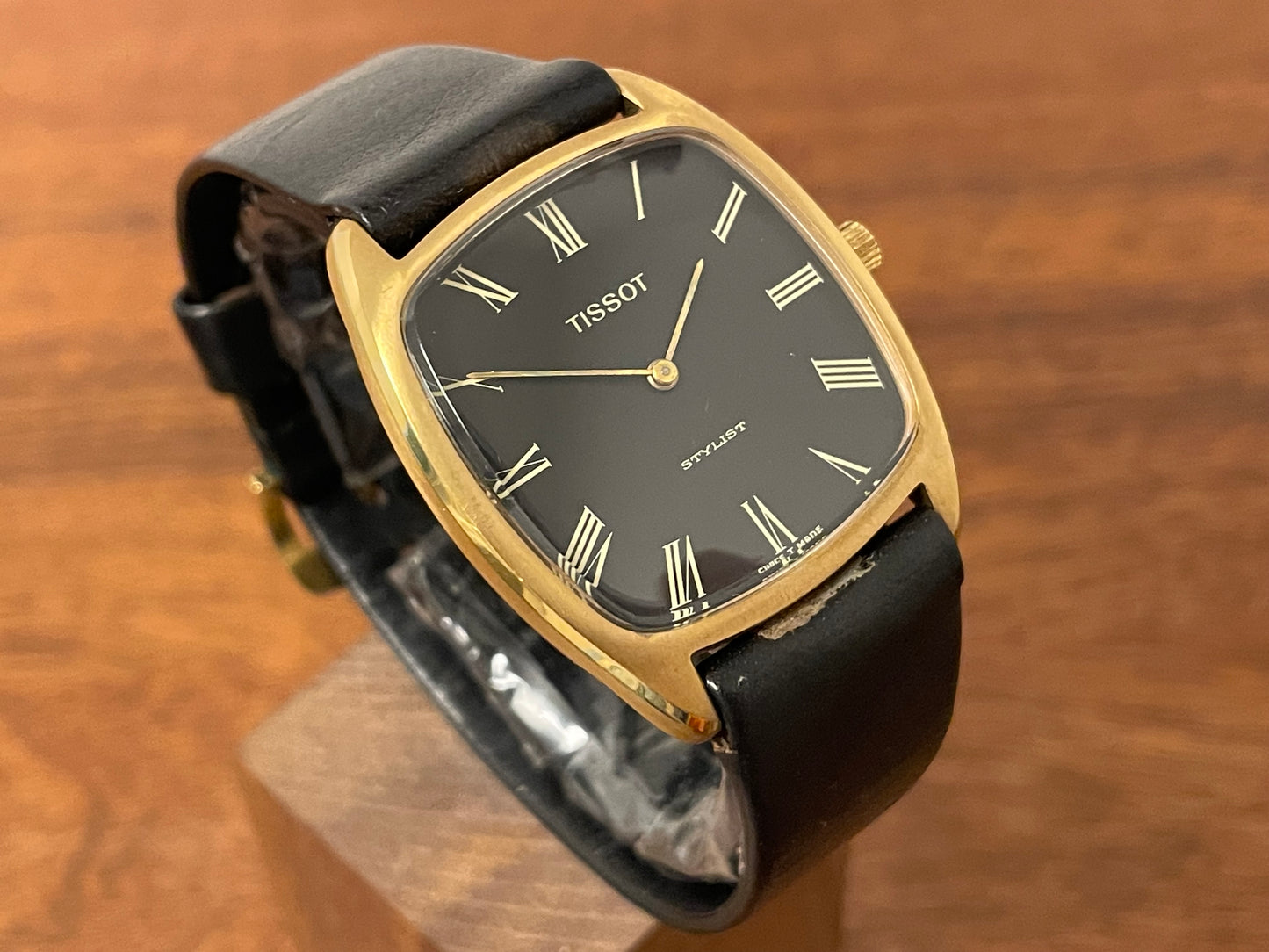 (1970s) Tissot Stylist dress watch - gold case - black dial w/ gold Roman numerals (NOS)