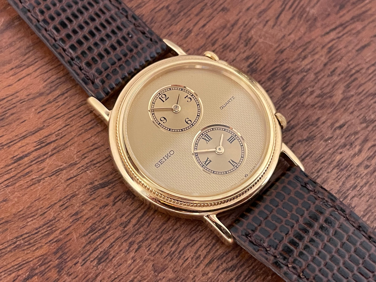 (1985) Seiko 1E20-0160 dual time dress watch - round case - gold textured dial w/ 2 subdials