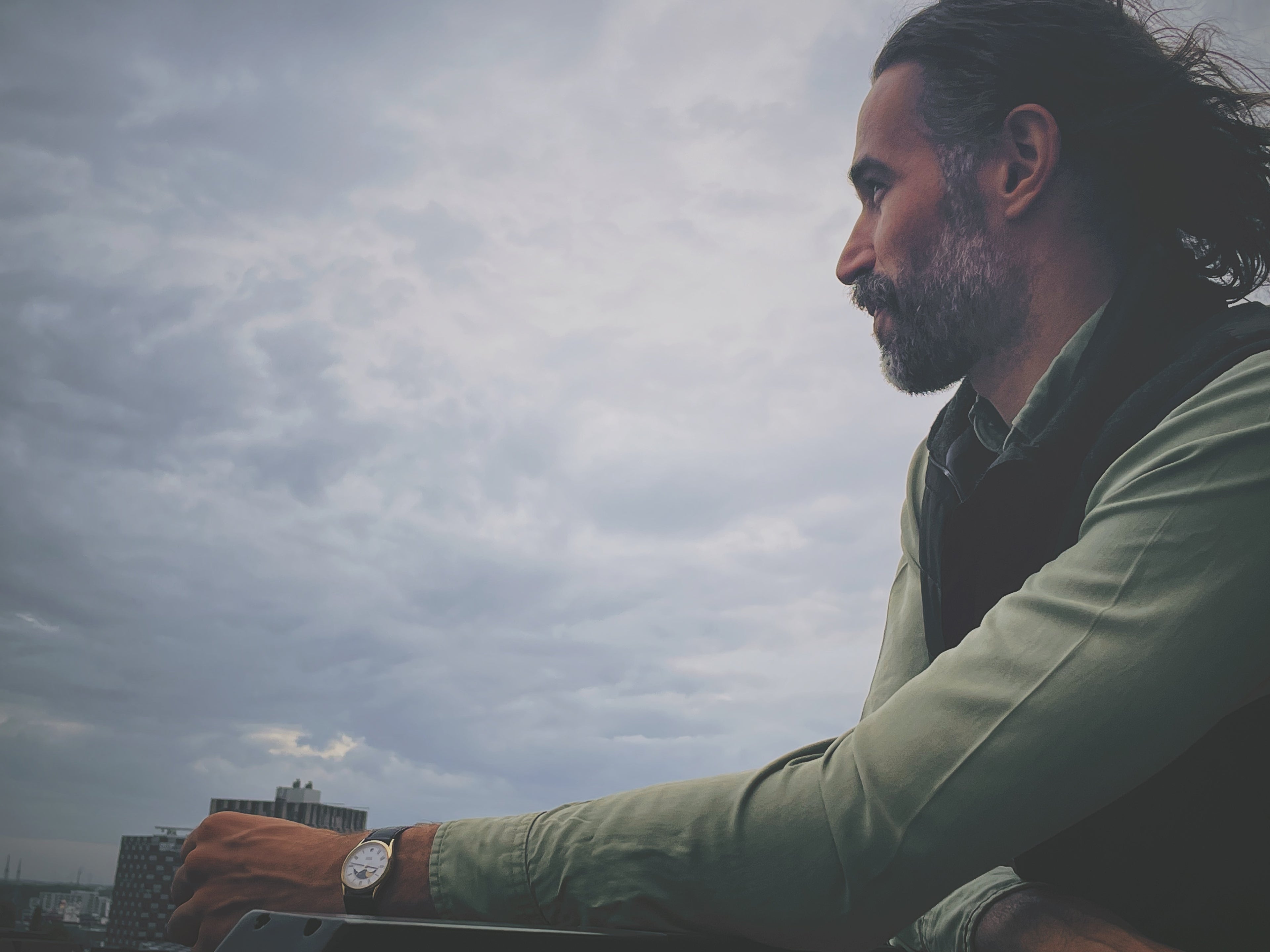 Man with vintage Seiko watch on wrist looking into the distance